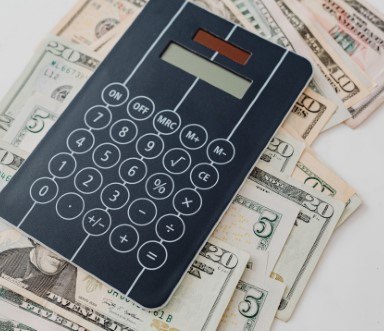 Calculator and cash on white counter